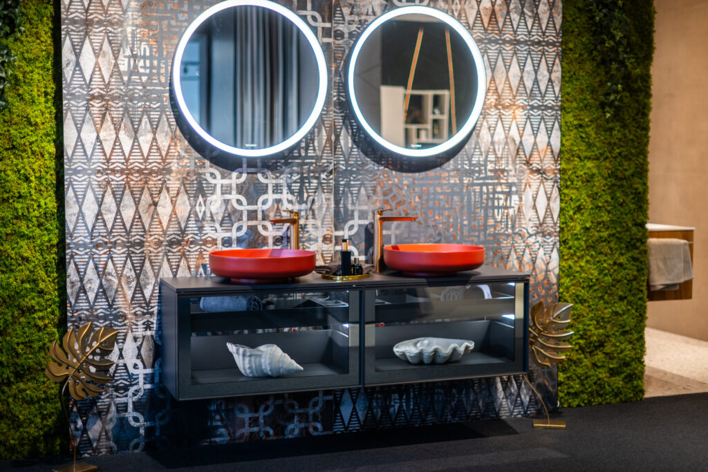 Design-Doppelwaschbecken mit roten Aufsatzbecken und LED-Spiegeln im Schauraum von MABELA Fliesen und Handels GmbH – moderne Bad- und Fliesengestaltung.